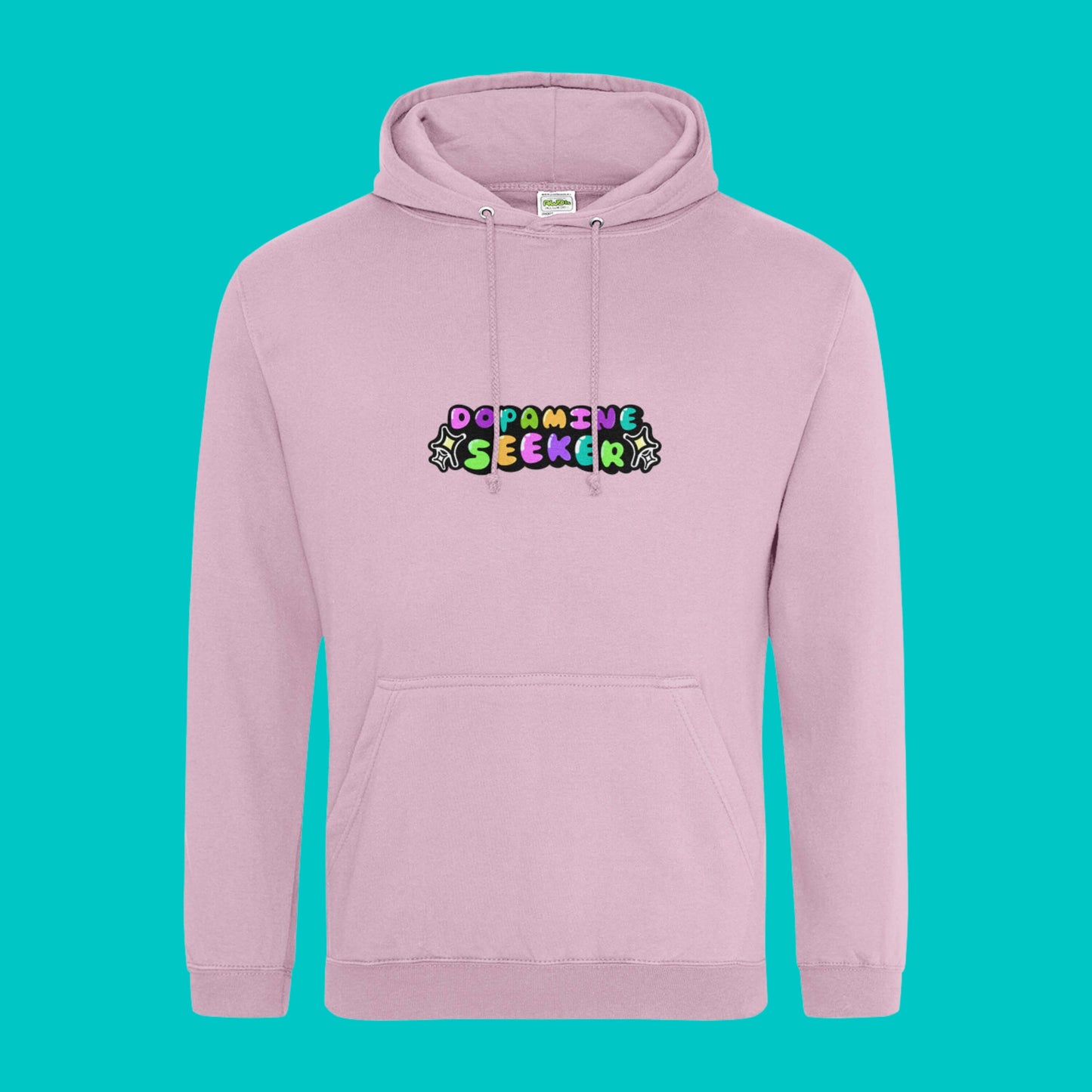 The Dopamine Seeker Hoodie in baby pink on a blue background. The hoodie design has 'dopamine seeker' written in the middle in rainbow bubble font and black sparkle outlines. The hoodie has pastel pink drawstrings and a large centre pocket. Design is raising awareness for ADHD and neurodivergence.