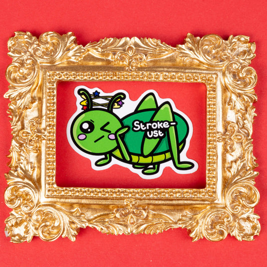 A cartoon sticker of a green grasshopper with a pained expression, blushing cheeks, and stars spinning around its head. The text "Stroke-ust" is written on the grasshopper's body. The sticker is framed by an ornate, gold decorative frame and placed on a solid red background. Hand drawn design created to raise awareness for strokes. 