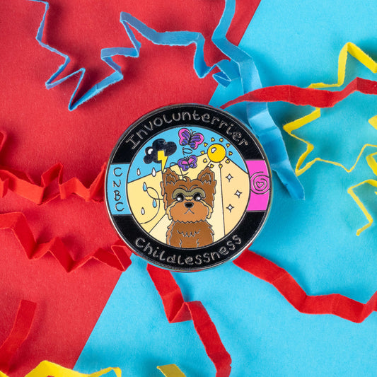 The Involunterrier Childlessness enamel pin by Innabox features a small terrier dog surrounded by imagery symbolising both joy and sadness, such as a sun, clouds, and butterflies. The pin is nestled in colourful paper cutouts, emphasising its vibrant design. Crafted for individuals affected by chronic illnesses or invisible disabilities, this pin aims to honour the experiences of those who face involuntary childlessness with strength and grace.